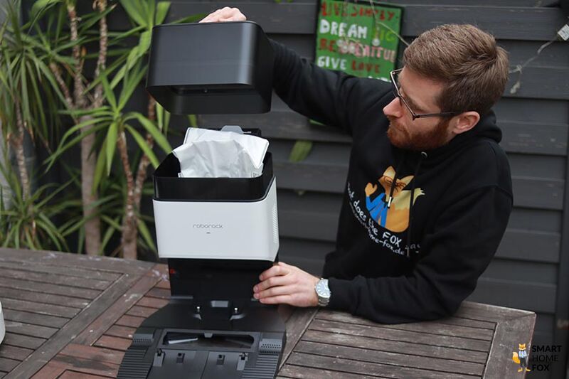 Opening the lid of the Roborock Q7 Max+ self-emptying base.